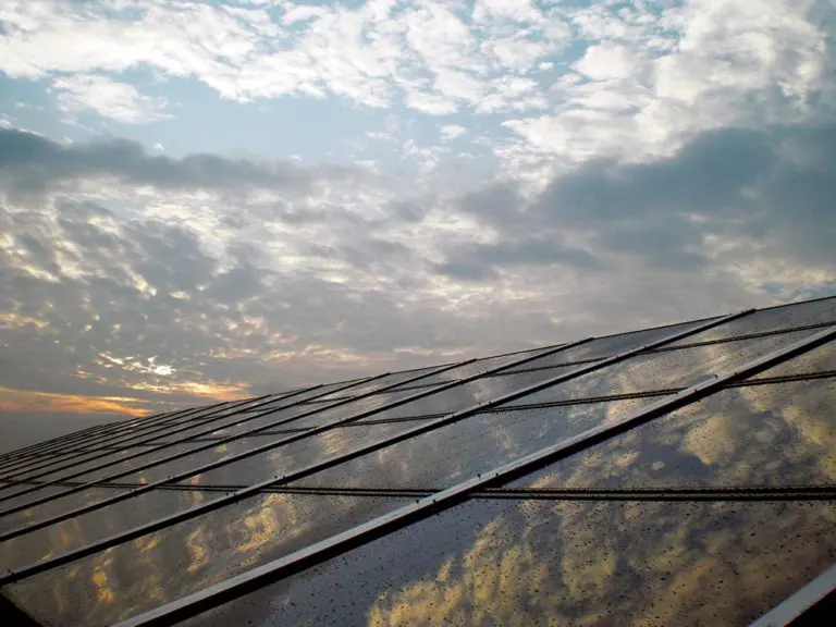 Clouds reflecting off a solar array during sunset