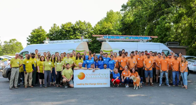 A group picture of the team at Southern Energy Management with a sign that says Leading the Change Since 2001