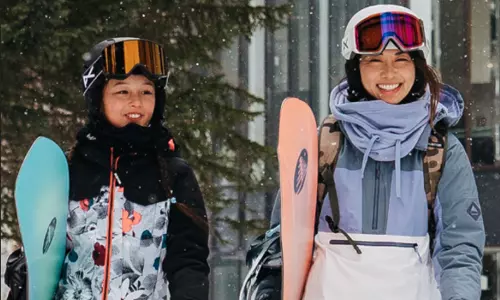 and adult and child in snowboarding gear from Burton outside in the snow